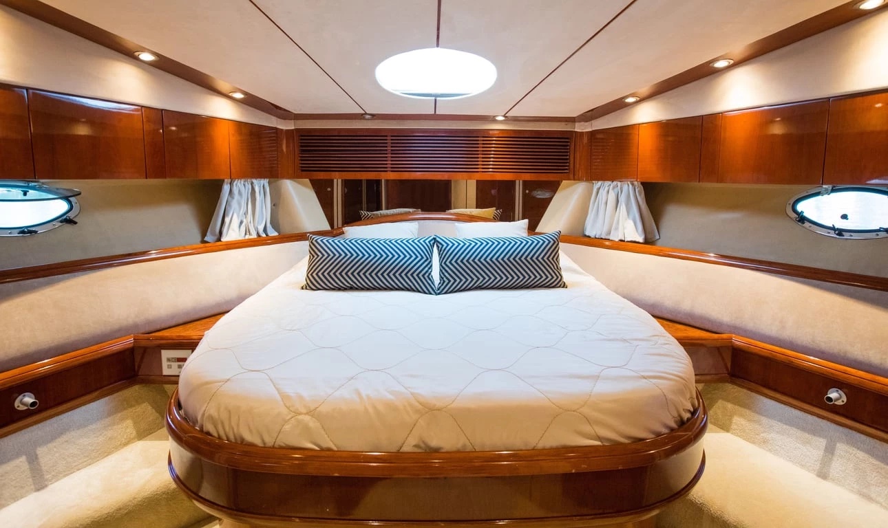 Forward master cabin of the Malavi 55 with island double bed, portholes and an overhead skylight