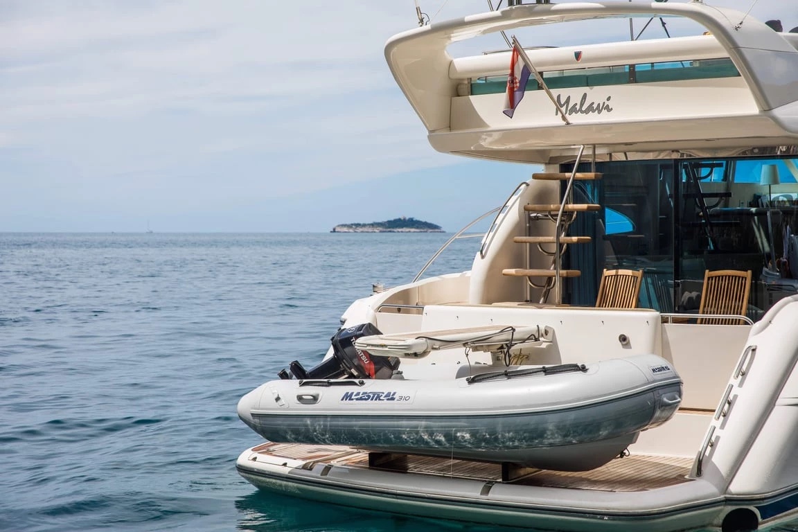 Maestral 310 tender with outboard on the Malavi 55 swim platform, ladder up to the flybridge