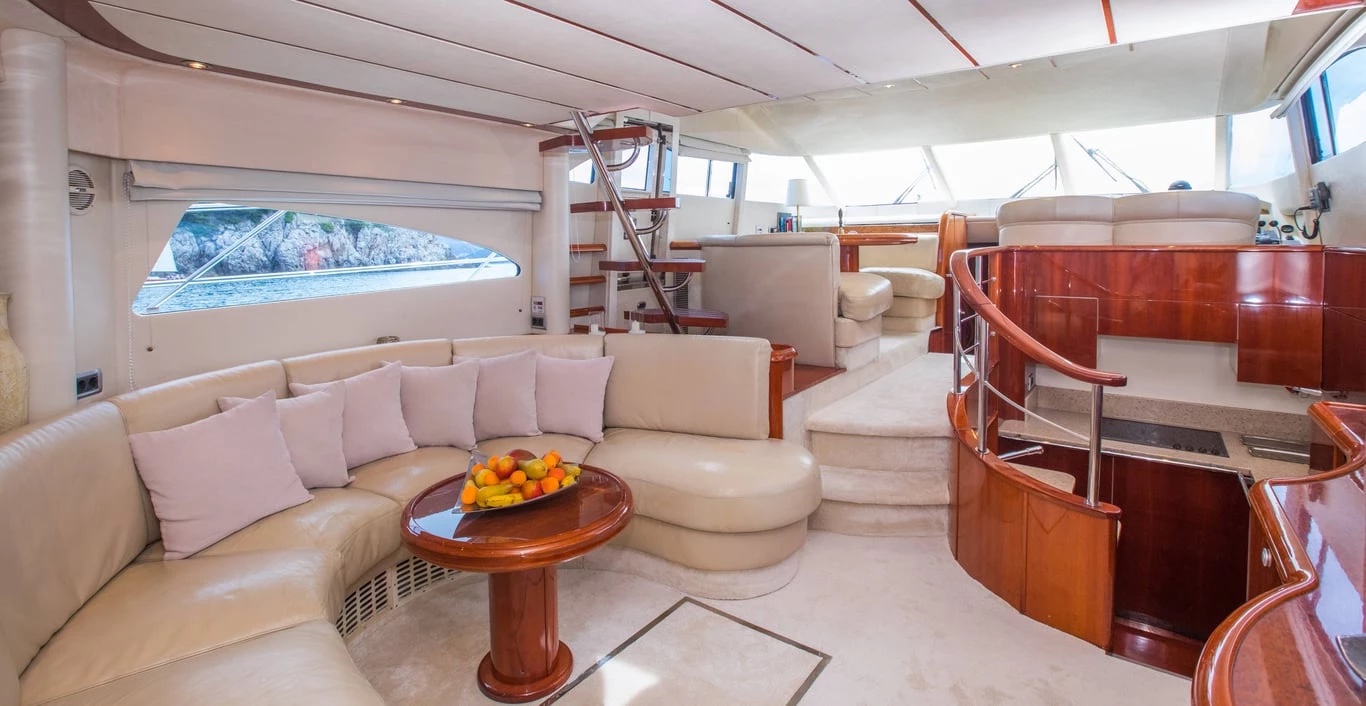 Wide view of the Malavi 55 saloon looking forward to the raised helm and galley stairs